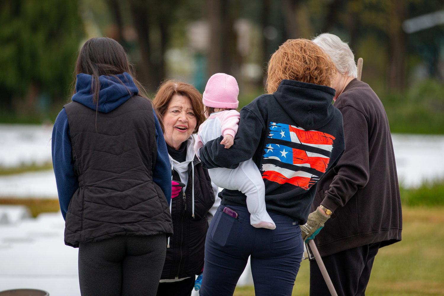 Marveen Rohr, the spokesperson for the Greenwood Memorial Park, greets a young child as additional members arrive for the work party to help restore the cemetery.